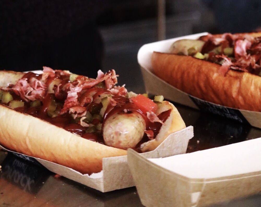 Loaded hot dogs with BBQ sauce and bacon